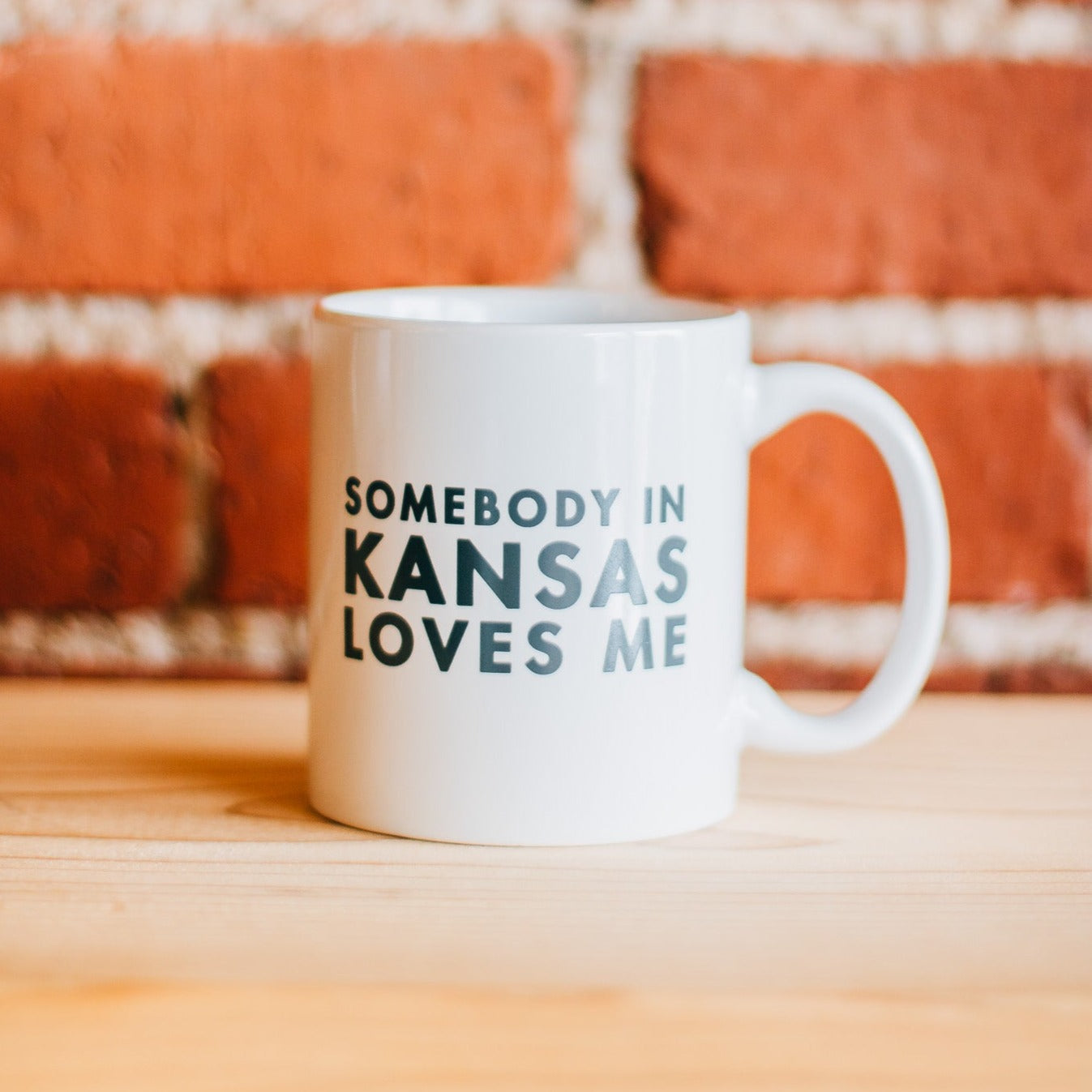 Somebody in Kansas Love Me Ceramic Mug